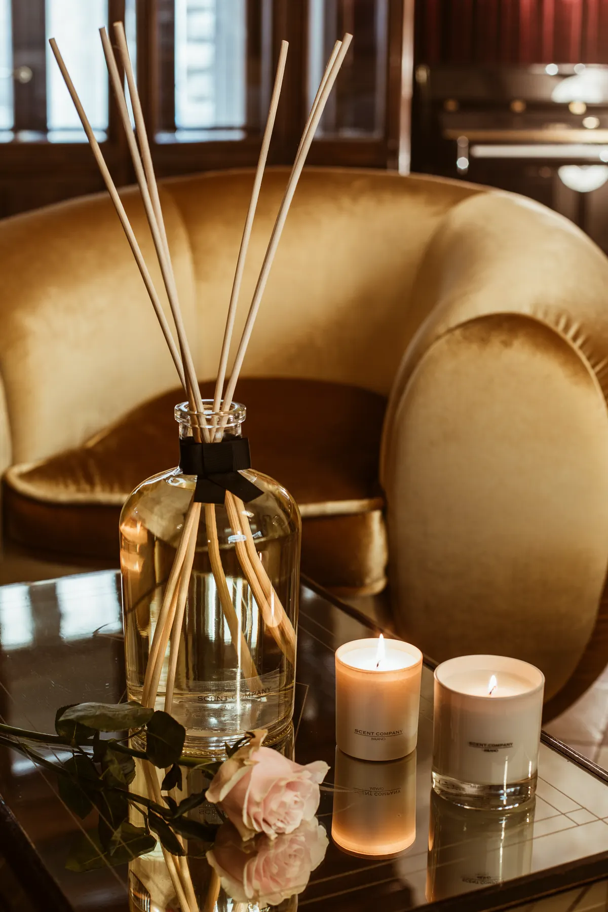 Calming candle and reed diffuser close up, illustrating a soothing scent profile